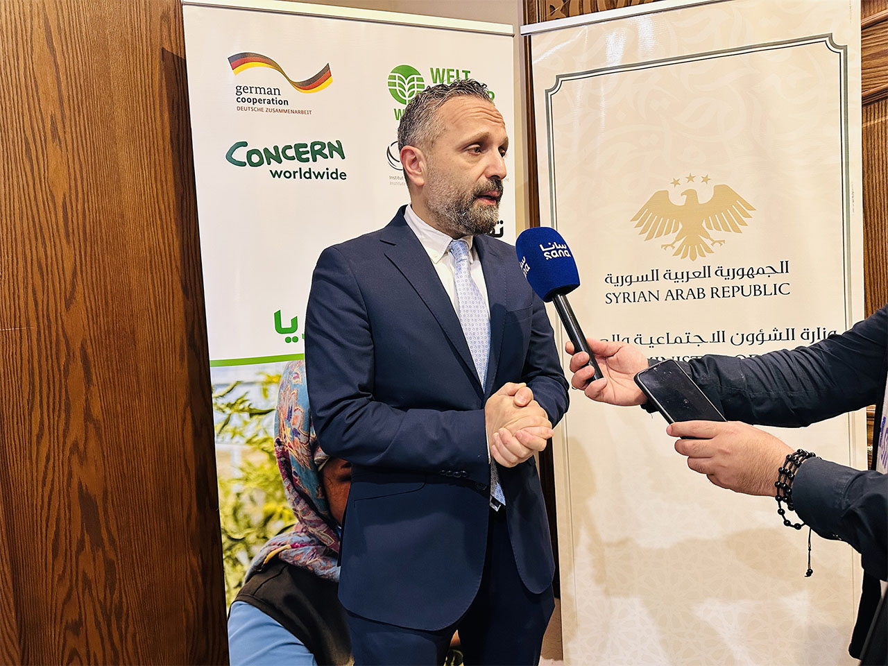Picture Description: Bahjat Al-Hajjar, Deputy Minister of Social Affairs and Labor, addresses media representatives during the launch of the 2025 Global Hunger Index in Damascus.Photo credits: Tasneem Haimoud