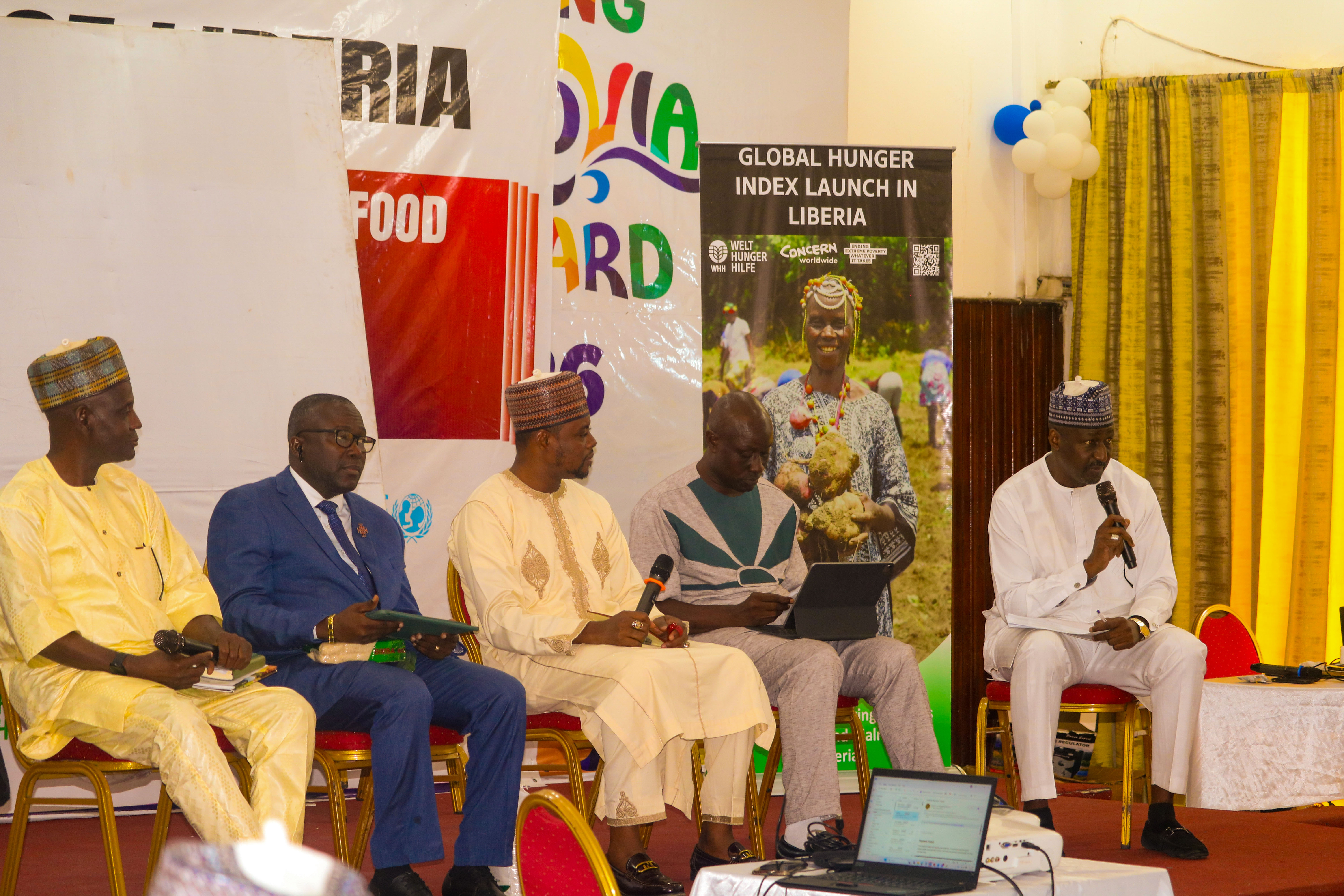 Experts discuss the System of Rice Intensification (SRI) during a panel session at the 2025 Global Hunger Index (GHI) launch in Liberia. From right to left: moderator Umar Nuhu Mohammed, Mohamed Kamara (AIIC/NRFL), Abubakar Usman Adam (Silvex), Robert Bimba (CHAP), and Abdulrahman Danbaba (SRI 2030). Picture credit: Welthungerhilfe/Abu Sekou Feika